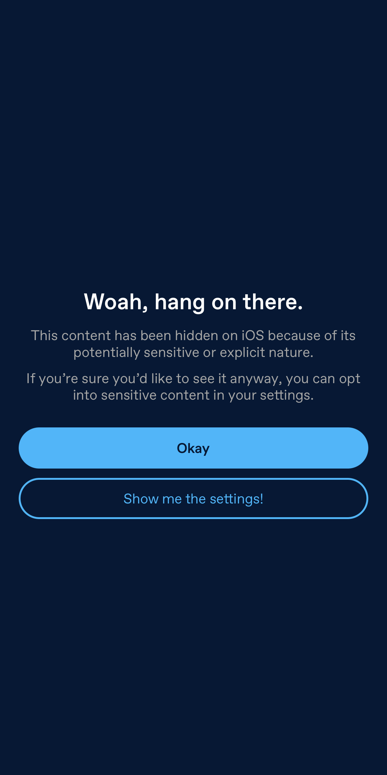 An overlay in the iOS app. The text reads: Woah, hang on there. This content has been hidden on iOS because of its potentially sensitive or explicit nature. If you're sure you'd like to see it anyway, you can opt into sensitive content in your settings. Two buttons below read: Okay and Show me the settings!